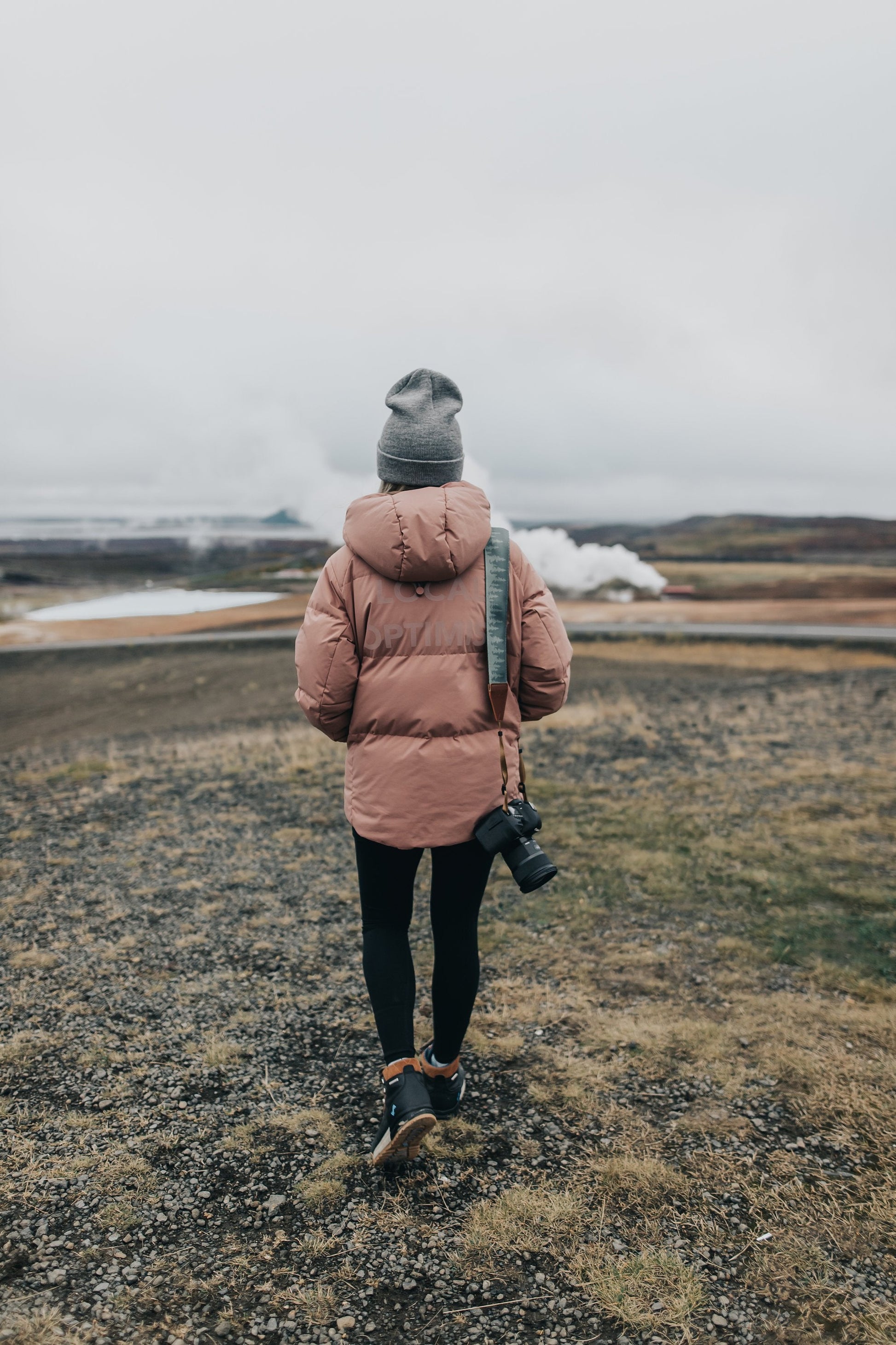 Women walking away wearing Wildtree pinetree camera strap