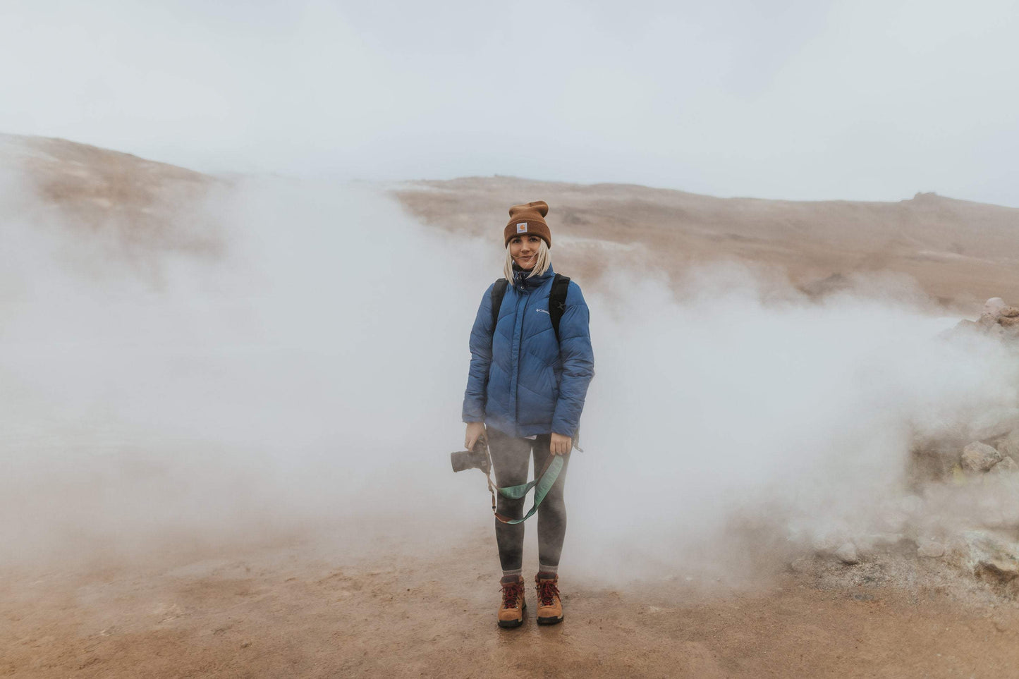 Portrait of women standing in fog holding dslr camera and Pinetree green Wildtree camera strap