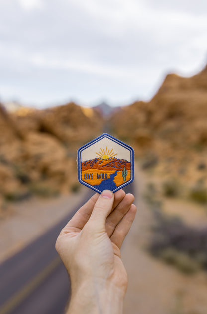 hand holding wildtree live wild iron on patch in Valley of fire state park