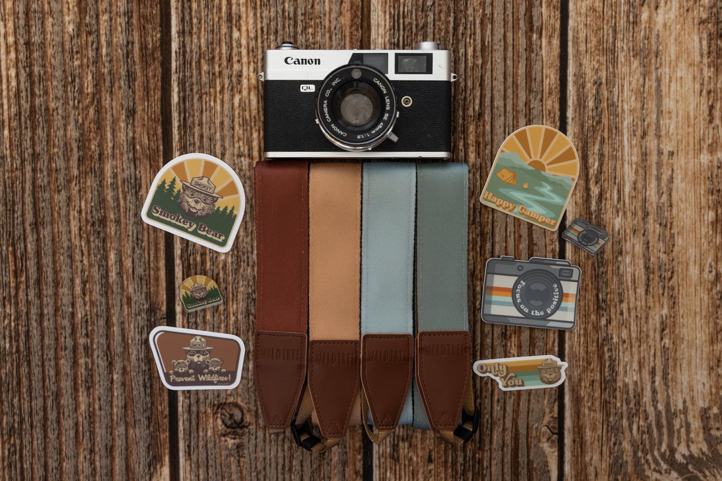 Only You Smokey Bear wildtree sticker on wood background with other camera strap, stickers and pins