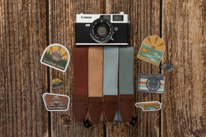 Smokey Bear acrylic pin on wood background with other camera strap, stickers and pins