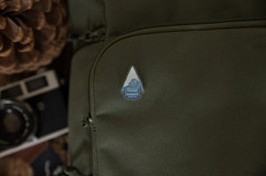 Yosemite National Park pin in shape of arrow head pinned on back pack